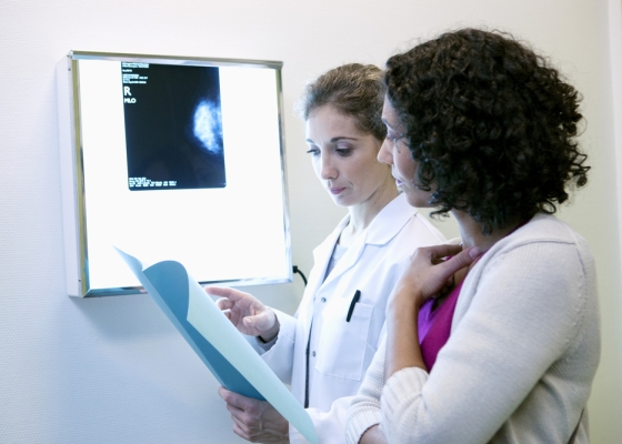 Woman of color discussing breast cancer disparities with a doctor
